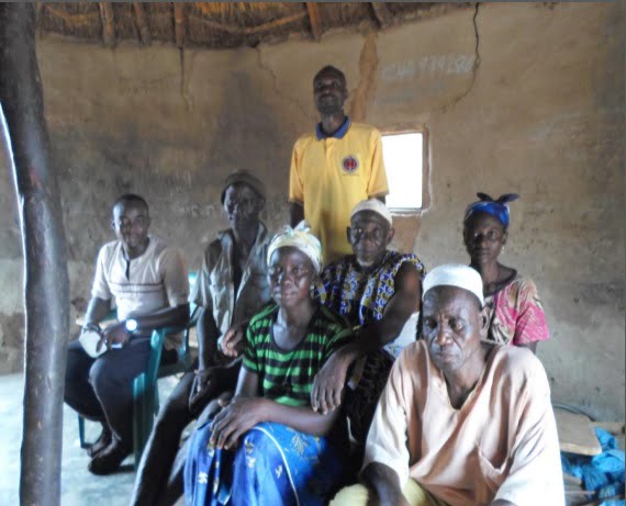 Untitled The Kunkoona is the nice elderly man in the picture on the second row sitting casually with his hands on the shoulders of the woman.